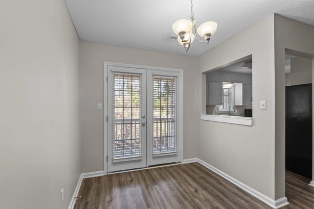 Dining area with French doors and a pass-through to the kitchen.