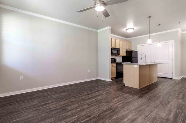 Spacious living area with a modern kitchen island and ample cabinet space.