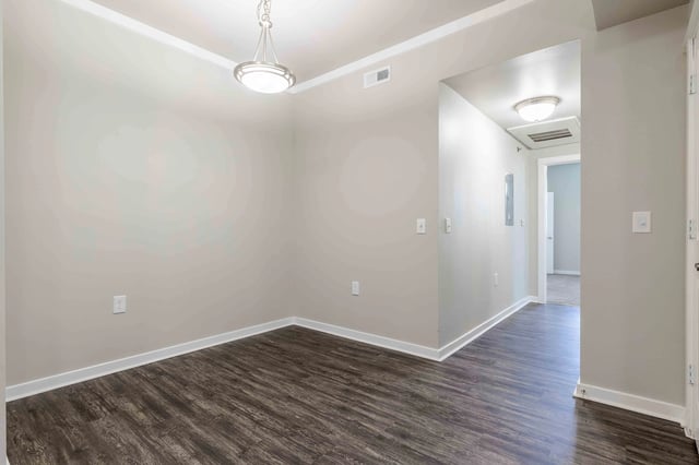 Empty dining area with wood-look flooring and a pendant light.