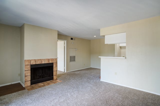 Living room with a fireplace and a breakfast bar.