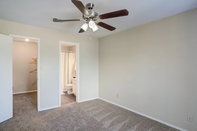 Bedroom with ceiling fan, closet, and adjoining bathroom.