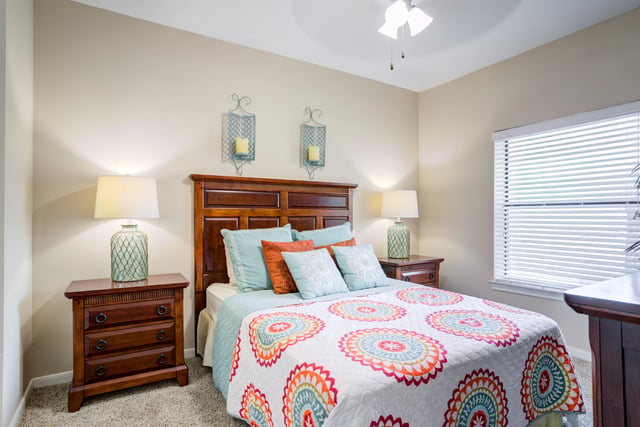Cozy bedroom with a queen-size bed, decorative pillows, and bedside tables.