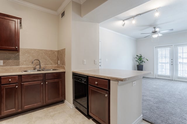 Modern kitchen with dark wood cabinets and granite countertops.