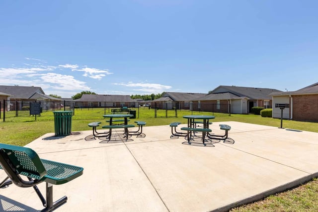 Outdoor picnic area with picnic tables and benches