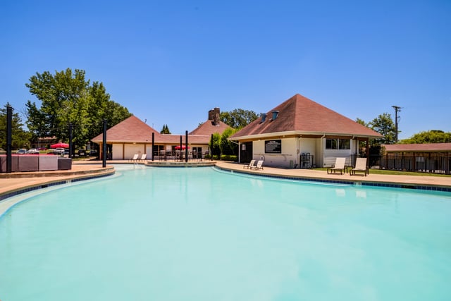 Resort-style swimming pool with lounge chairs and cabana.