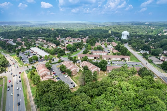 Aerial view of apartment buildings and surrounding trees