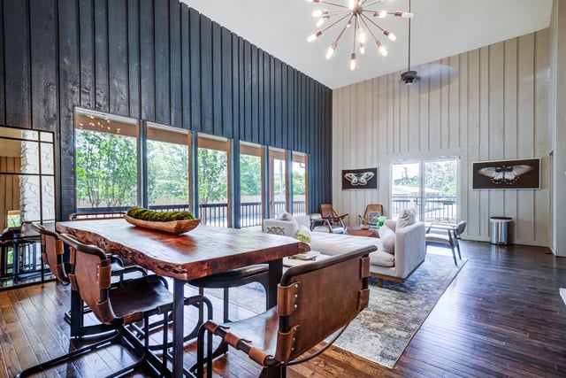Spacious living and dining area with a live-edge wood table, leather chairs, and modern decor.