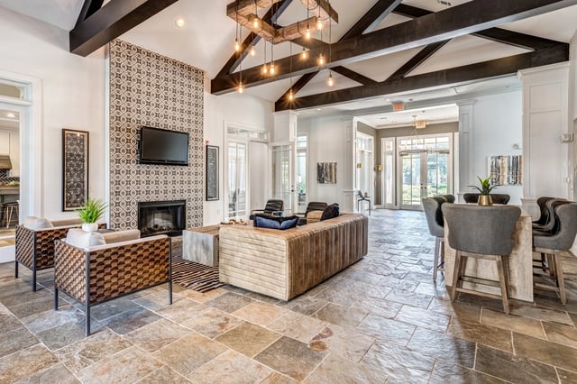 Lobby seating area with fireplace, TV, and bar stools.