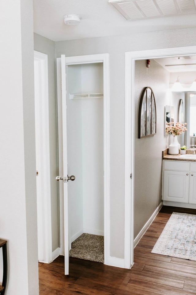 Hallway closet and bathroom vanity.