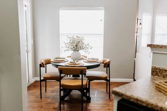 Dining area with a round table set for four.