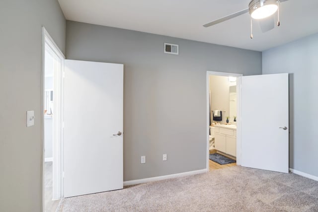 Bedroom with two doors, one opening to a bathroom.