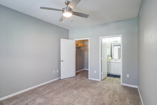 Bedroom with ceiling fan, open closet, and doorway to bathroom.