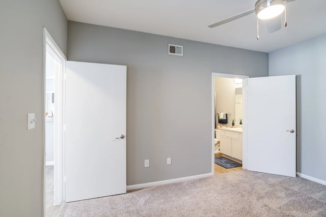 Bedroom with doors leading to other rooms and a view of the bathroom.