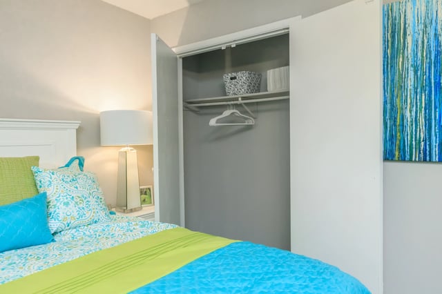 Bedroom closet with built-in shelves and empty hangers