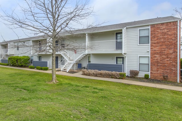 Exterior view of apartment buildings with stairs and balconies.