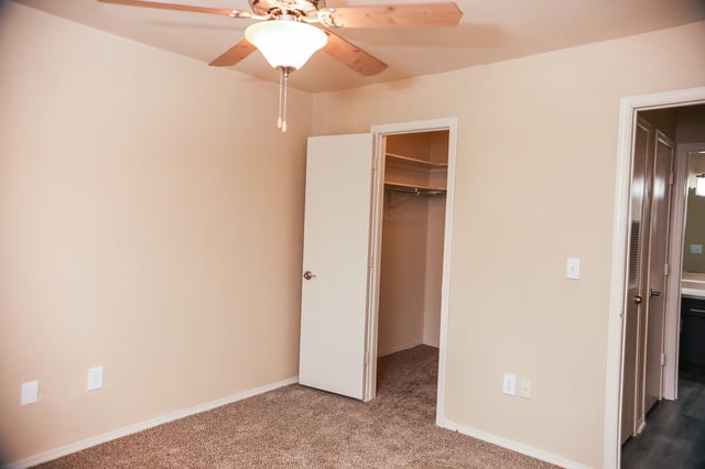 Bedroom with ceiling fan and open closet