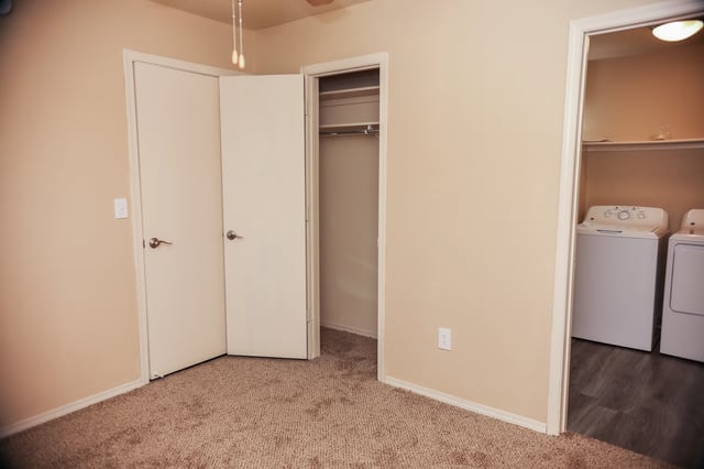 Bedroom with closet and laundry area