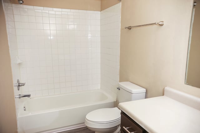 Bathroom with tub, toilet, and vanity.
