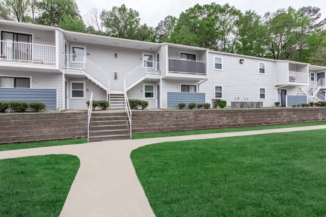 Exterior view of apartment buildings with balconies and stairs.