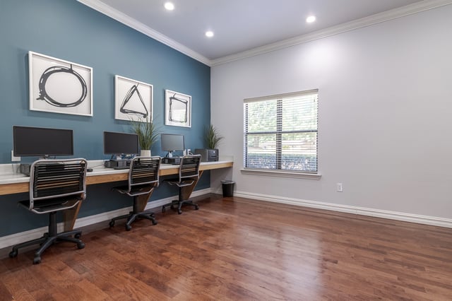 Business center with computers and desks.
