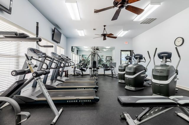 Gym with treadmills, ellipticals, and weight machines