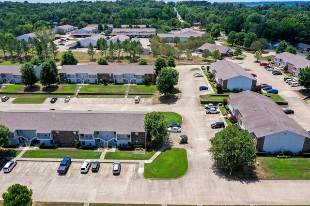 Aerial view of apartment buildings and surrounding grounds.