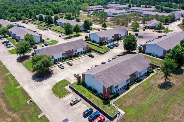 Aerial view of apartment buildings and surrounding grounds.