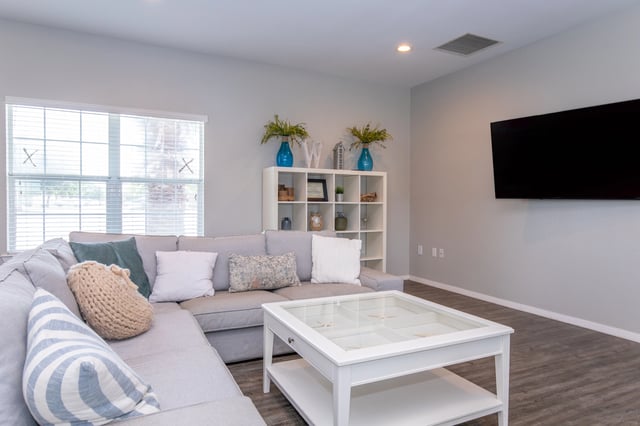 Living room with a sectional sofa, coffee table, and television.