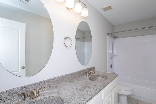 Bathroom with double vanity and shower/tub combo