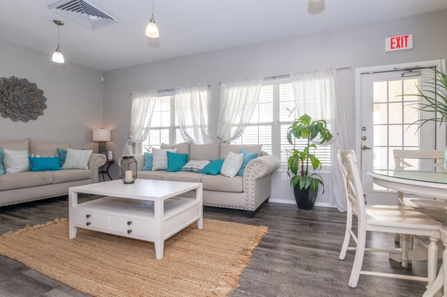 Seating area in a community lounge with sofas and a coffee table.