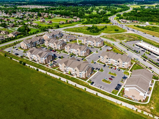 Aerial view of apartment buildings and surrounding neighborhood.