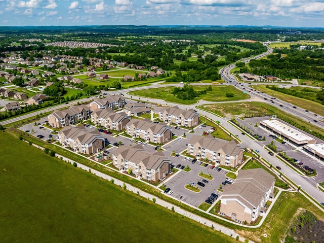 Aerial view of apartment buildings and surrounding neighborhood