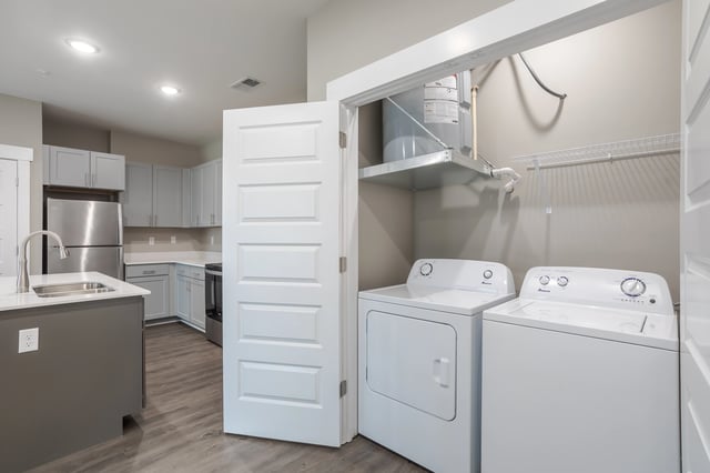 In-unit washer and dryer next to kitchen