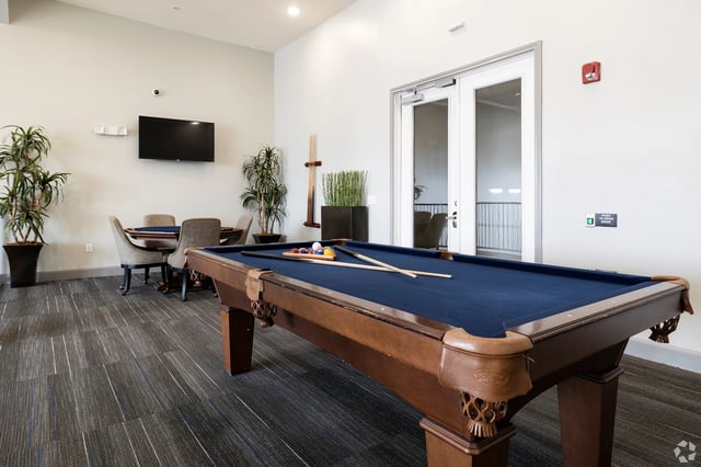 Billiard table and seating area in the community lounge.