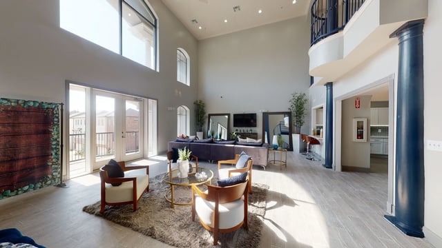 Spacious community lounge area with modern seating and high ceilings.
