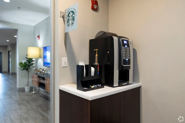 Starbucks coffee station with coffee machine and supplies.