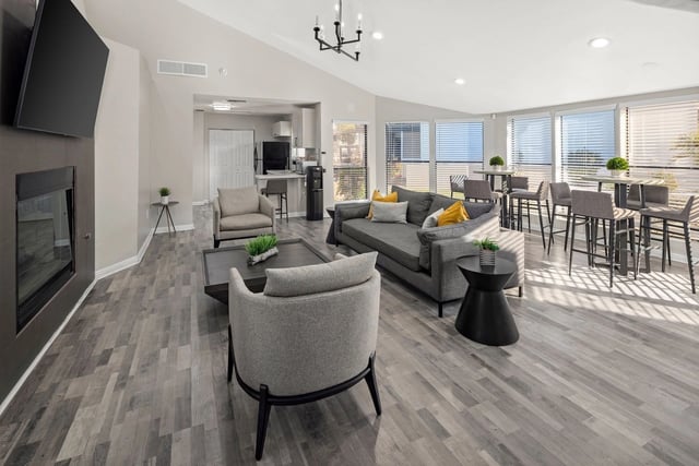 Modern lounge area with fireplace, comfortable seating, and bar seating.