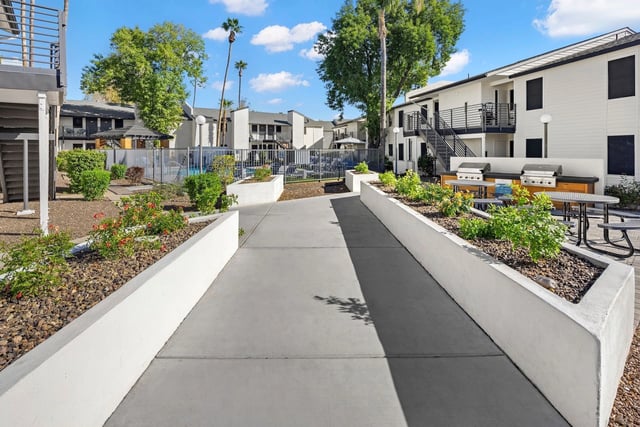 Walkway leading to outdoor grilling area and pool.