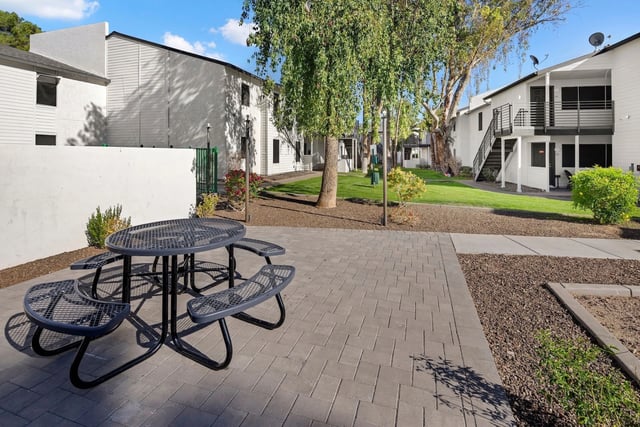 Outdoor picnic table in a courtyard area of an apartment complex.