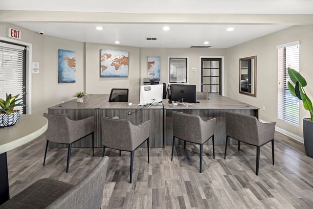 Modern leasing office with multiple workstations and comfortable seating.