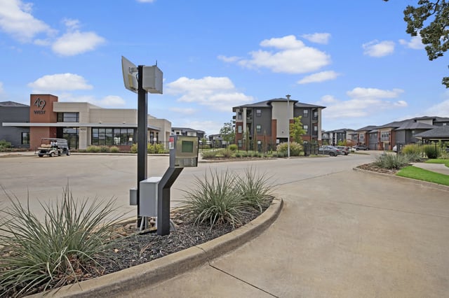 Entrance to 49 West apartment complex with modern buildings and landscaping.
