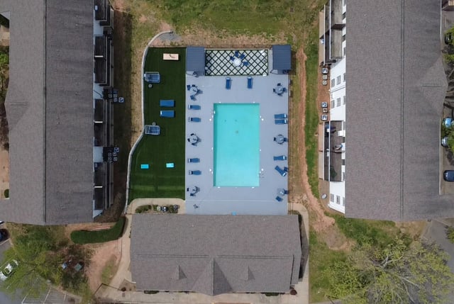 Aerial view of a swimming pool with lounge chairs and umbrellas.