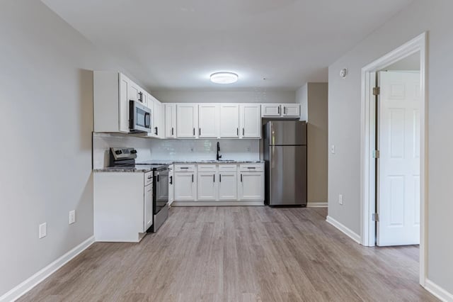 Kitchen with white cabinets and stainless steel appliances.