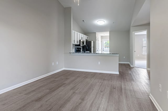 Open concept living area with kitchen and dining bar.