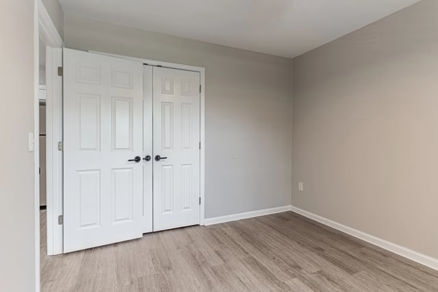 Interior view of a bedroom with double closet doors.
