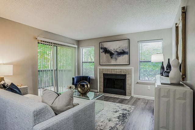Cozy living room with a fireplace, sofa, and glass coffee table.