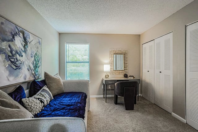 Bedroom with daybed, desk, and closet.