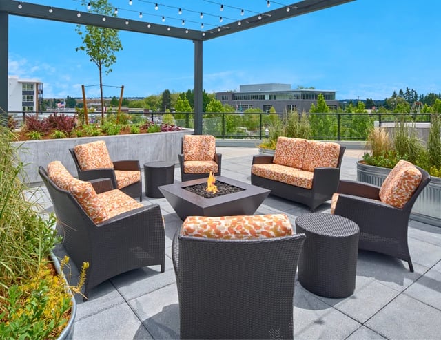 Rooftop patio with fire pit and seating.