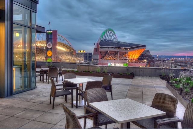 Rooftop patio overlooking a stadium.