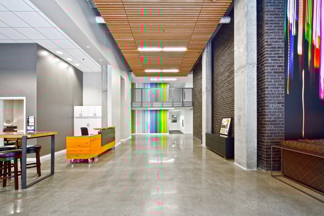 Modern lobby with reception desk and colorful art installation